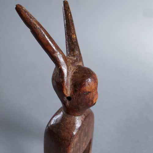 Old Jimini or Djimini wood heddle pulley with horned figure from Ivory Coast.