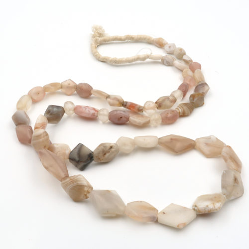 a stand of ancient quartz stone and rock crystal tabular beads