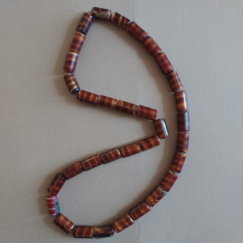 Antique tortoise shell glass trade beads.