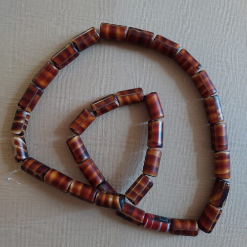 Antique tortoise shell glass trade beads.