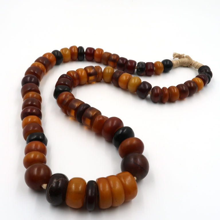 strand of antique phenolic resin amber beds from the african trade collected in mali
