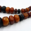Long strand of phenolic resin amber beads from the African trade.