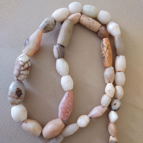 Mixed strand of graduated stone beads.