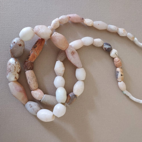 Mixed strand of graduated stone beads.