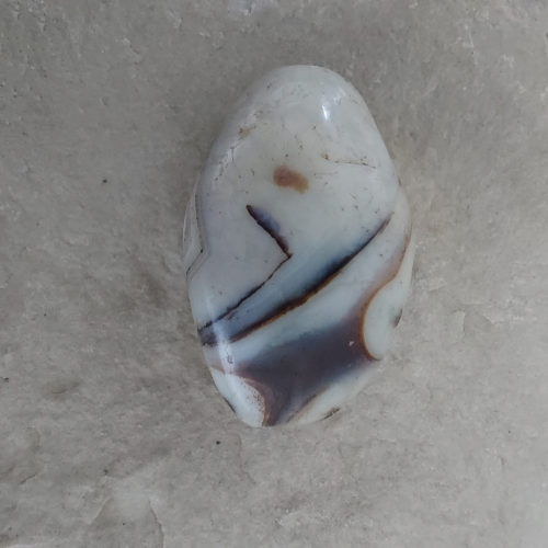 Stone bead with eyes.