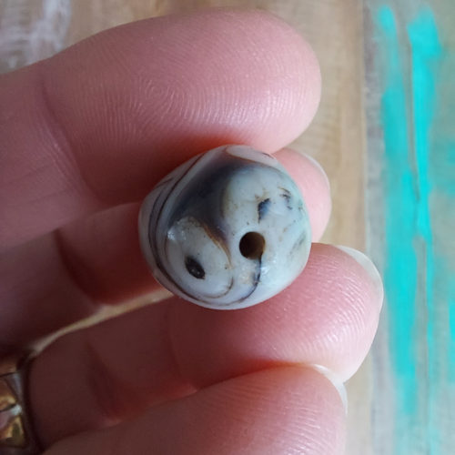 Stone bead with eyes.