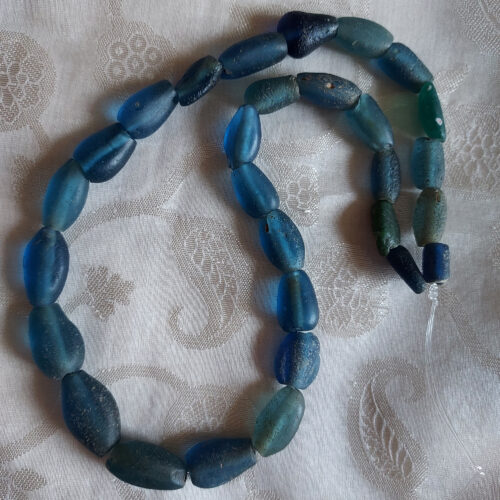 Ancient Islamic period excavated oval glass beads from Djenne Mali.