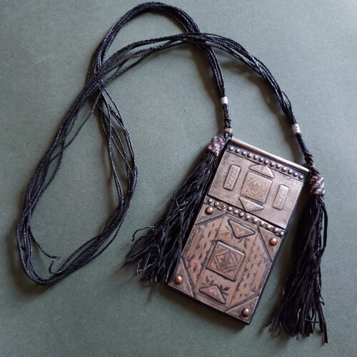 Amulet necklace in silver of large rectangular shape.