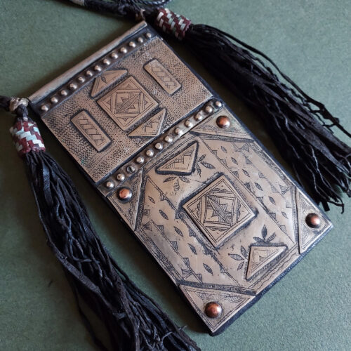 Amulet necklace in silver of large rectangular shape.