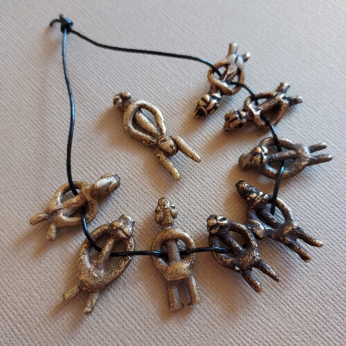 Authentic Lobi metal figure pendants with a nice patina.