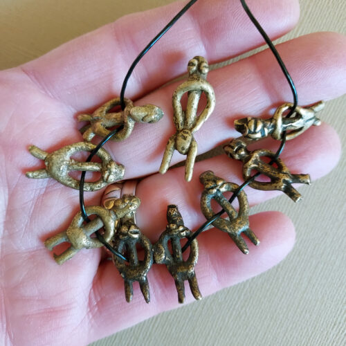 Authentic Lobi metal figure pendants with a nice patina.