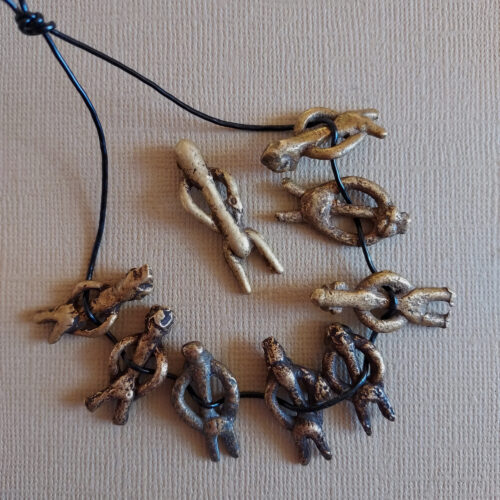 Authentic Lobi metal figure pendants with a nice patina.