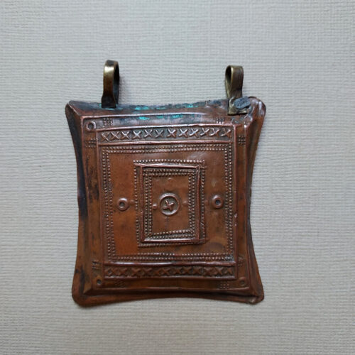 Tuareg tcherot amulet made of copper with a fine repoussé pattern from Niger.