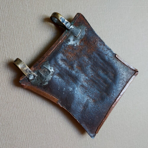 Tuareg tcherot amulet made of copper with a fine repoussé pattern from Niger.