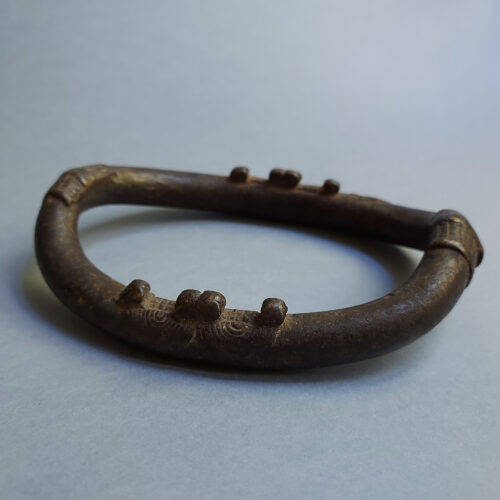 Old Senufo African anklet with applied elements.