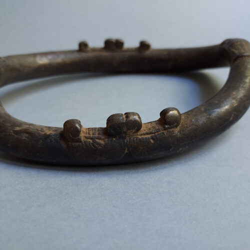 Old Senufo African anklet with applied elements.