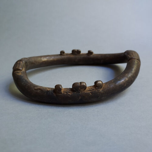 Old Senufo African anklet with applied elements.