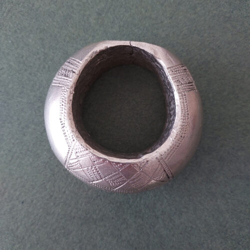 Large Fulani silver pendant with etched pattern.