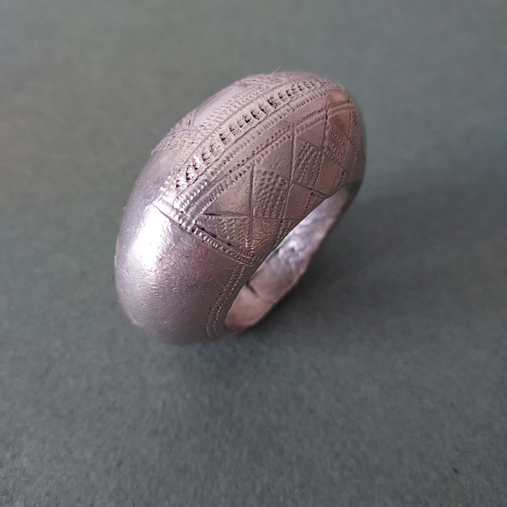 Large Fulani silver pendant with etched pattern.