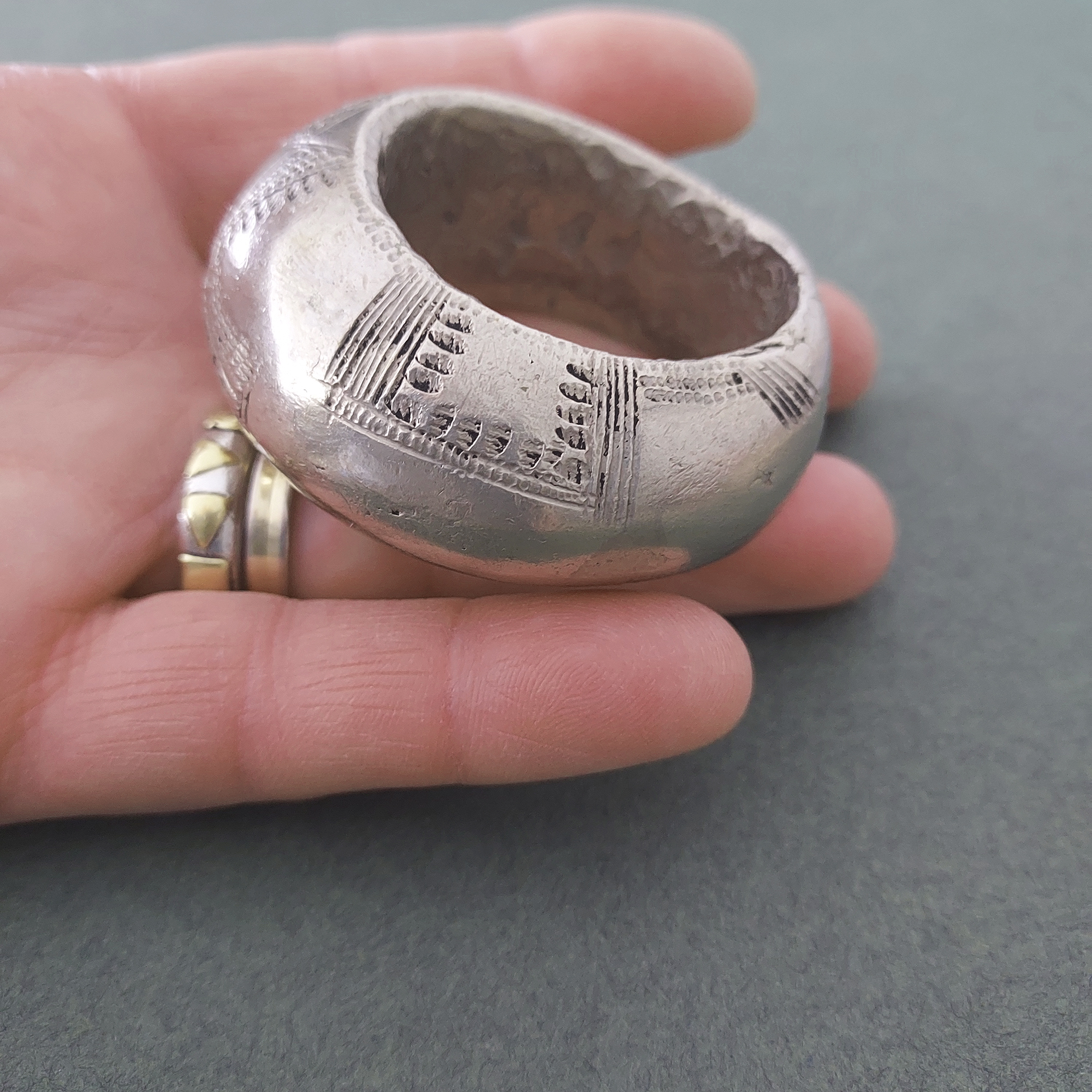 Large Fulani silver pendant with etched pattern.
