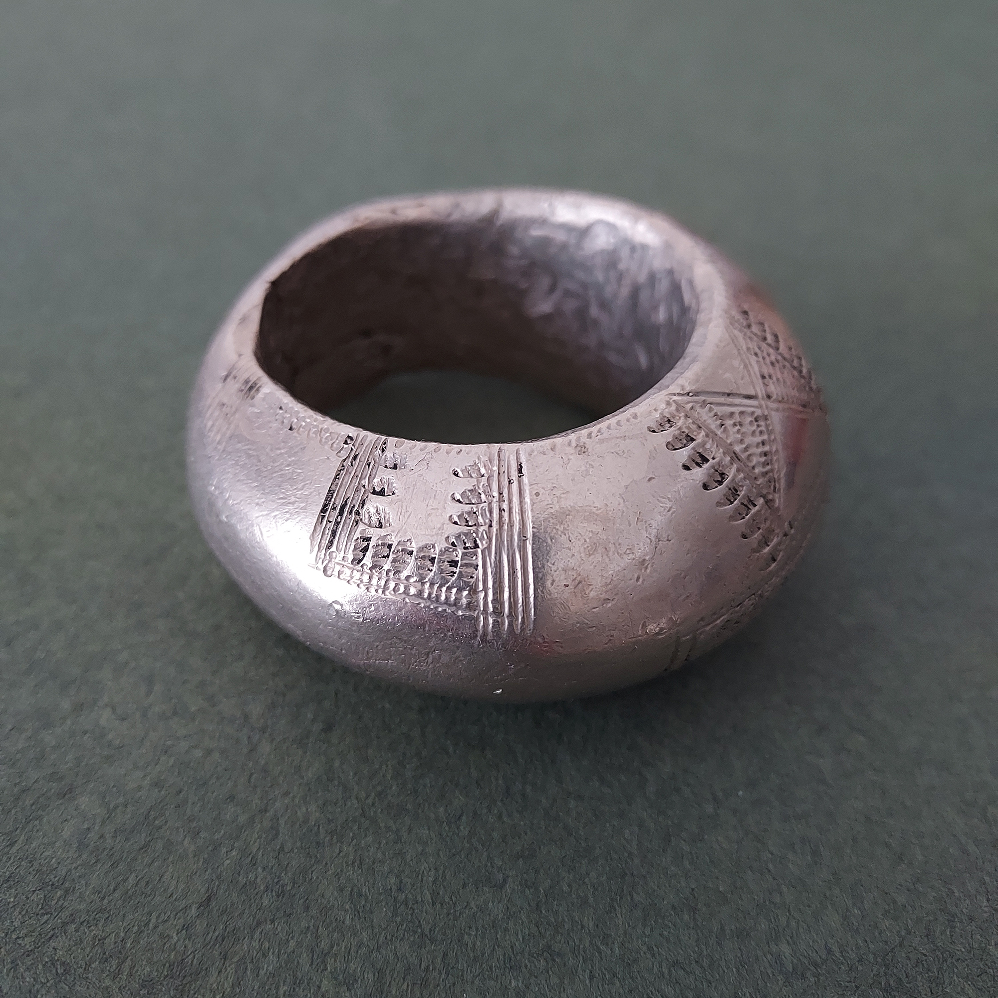 Large Fulani silver pendant with etched pattern.