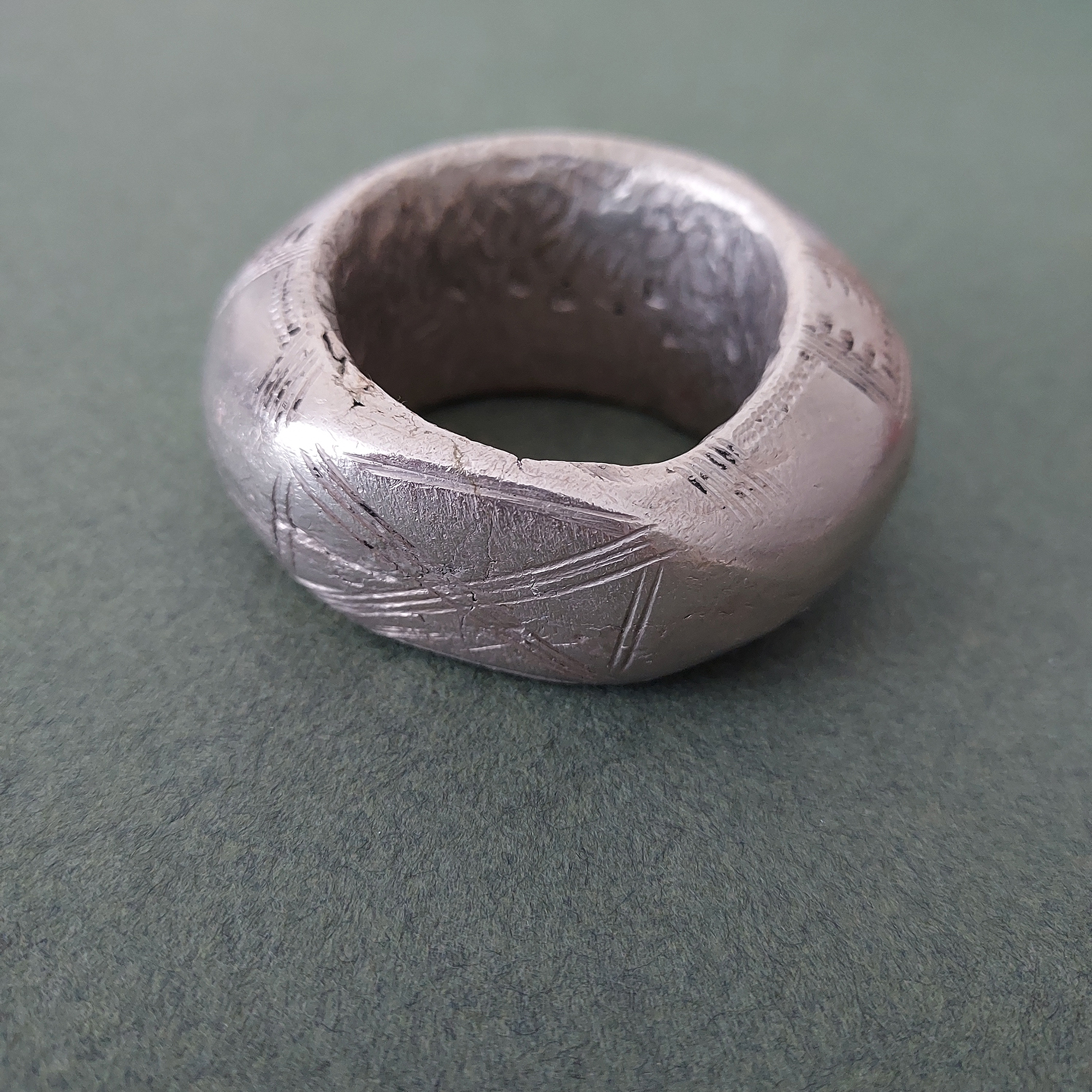 Large Fulani silver pendant with etched pattern.