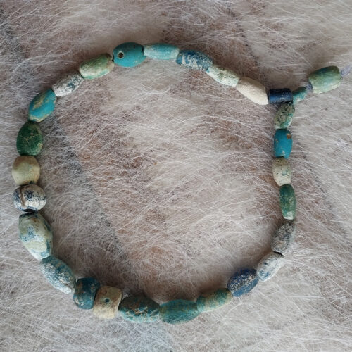 Ancient glass beads in turquoise, blue and green colours